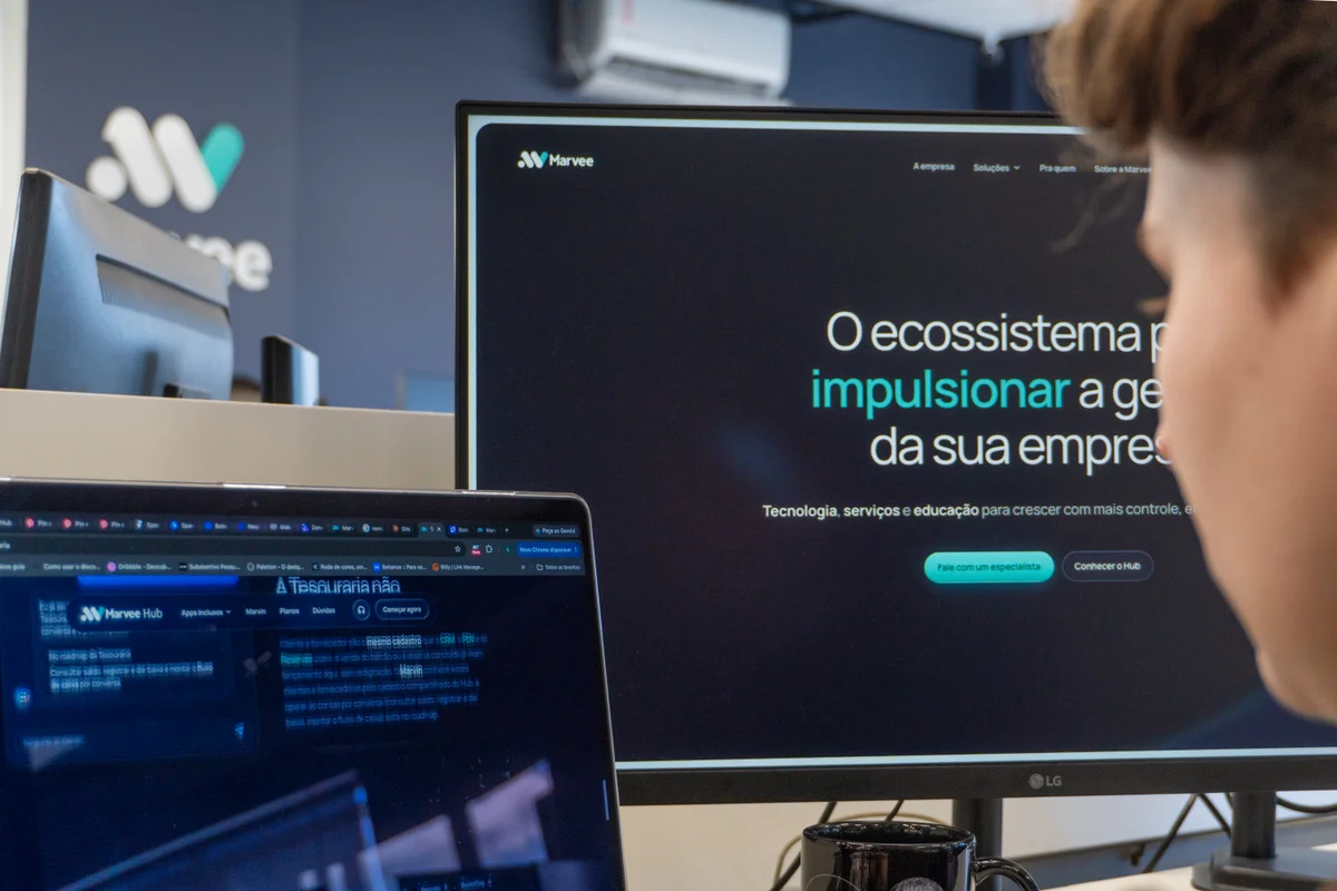 Site da Marvee e Marvee Hub nas telas do escritório